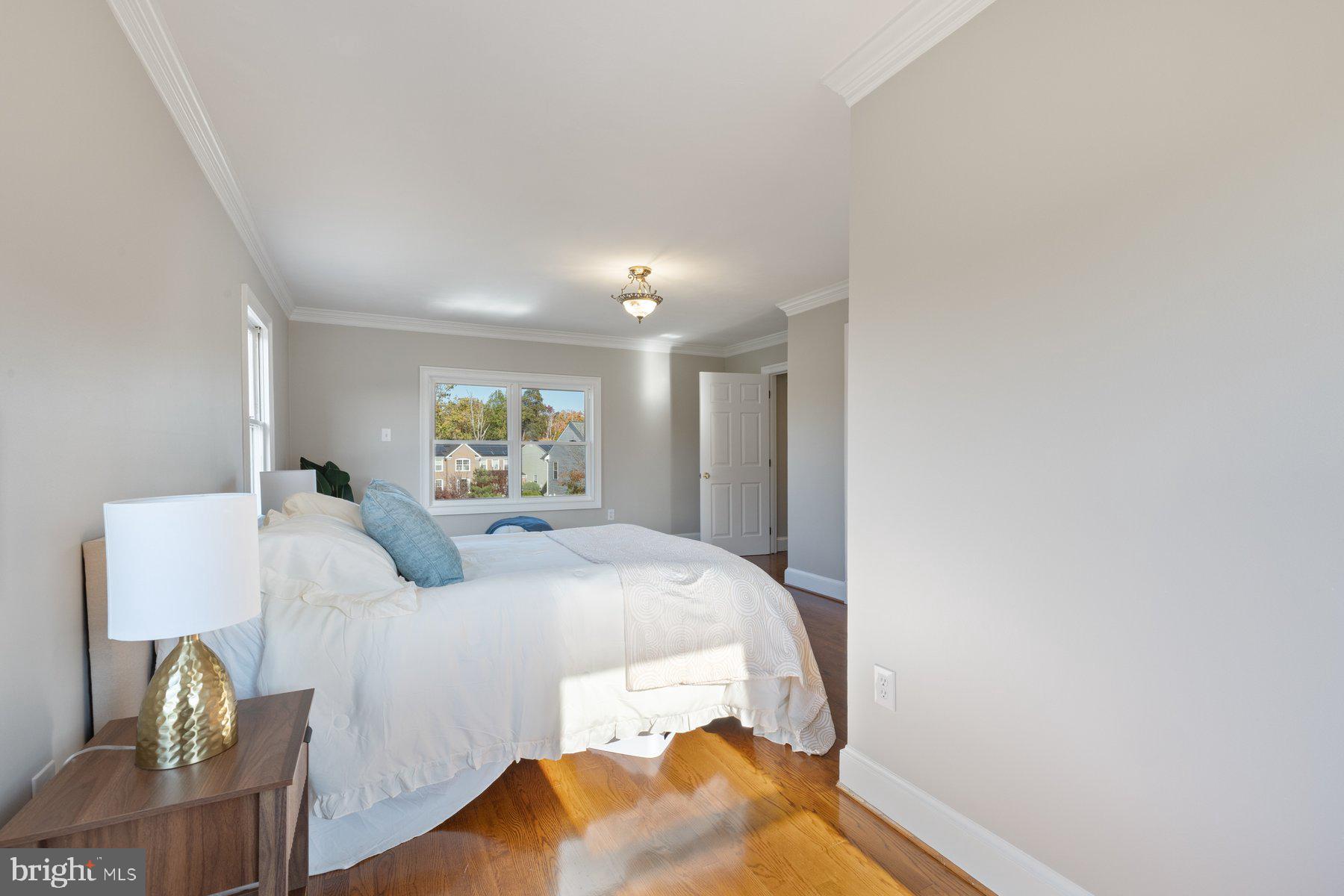 7005 Beacon Light Road Riverdale, MD 20737 - Photo 26 of 45 a bedroom with a bed and a lamp with window