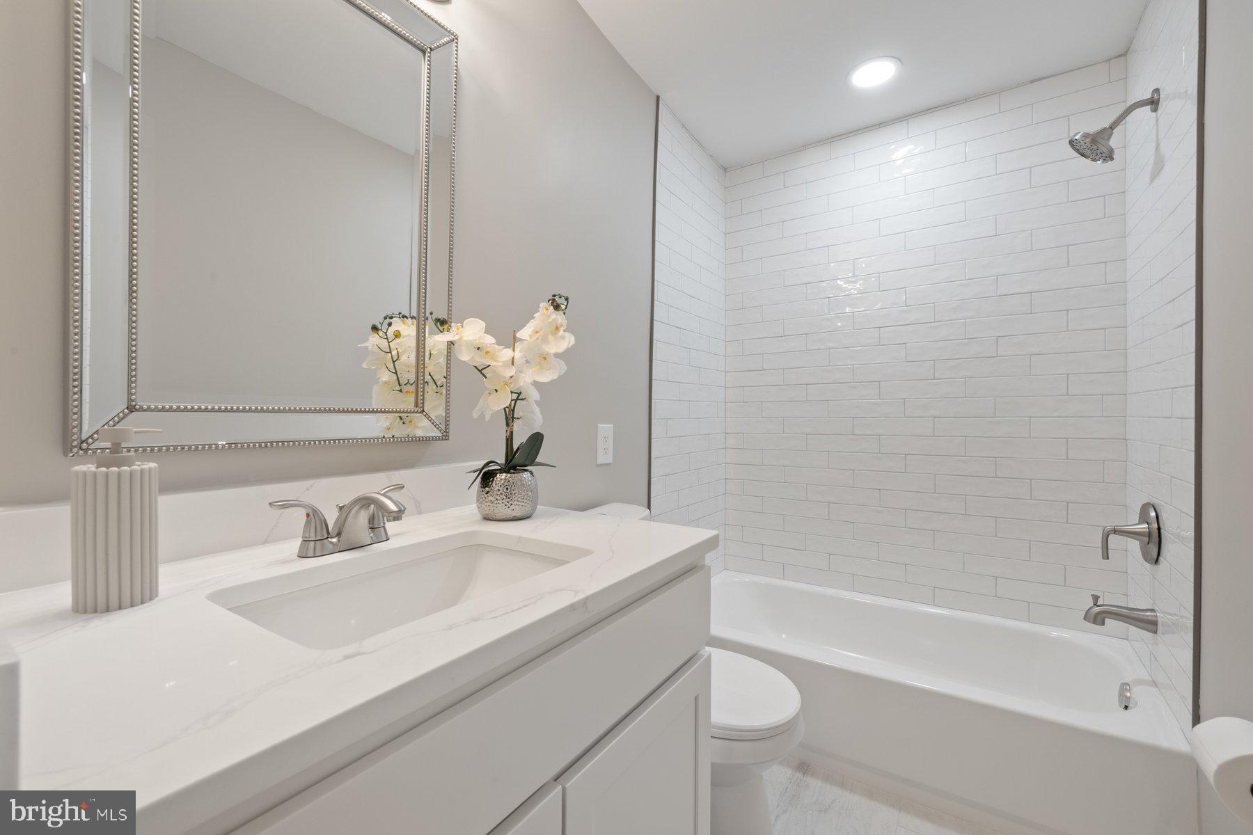 7005 Beacon Light Road Riverdale, MD 20737 - Photo 30 of 45 a bathroom with a sink a toilet and shower