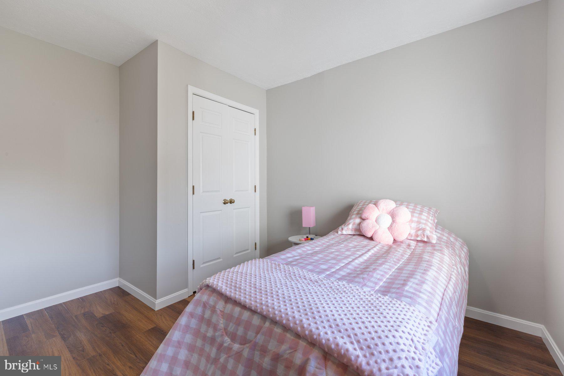 7005 Beacon Light Road Riverdale, MD 20737 - Photo 32 of 45 a bedroom with a bed and wooden floor