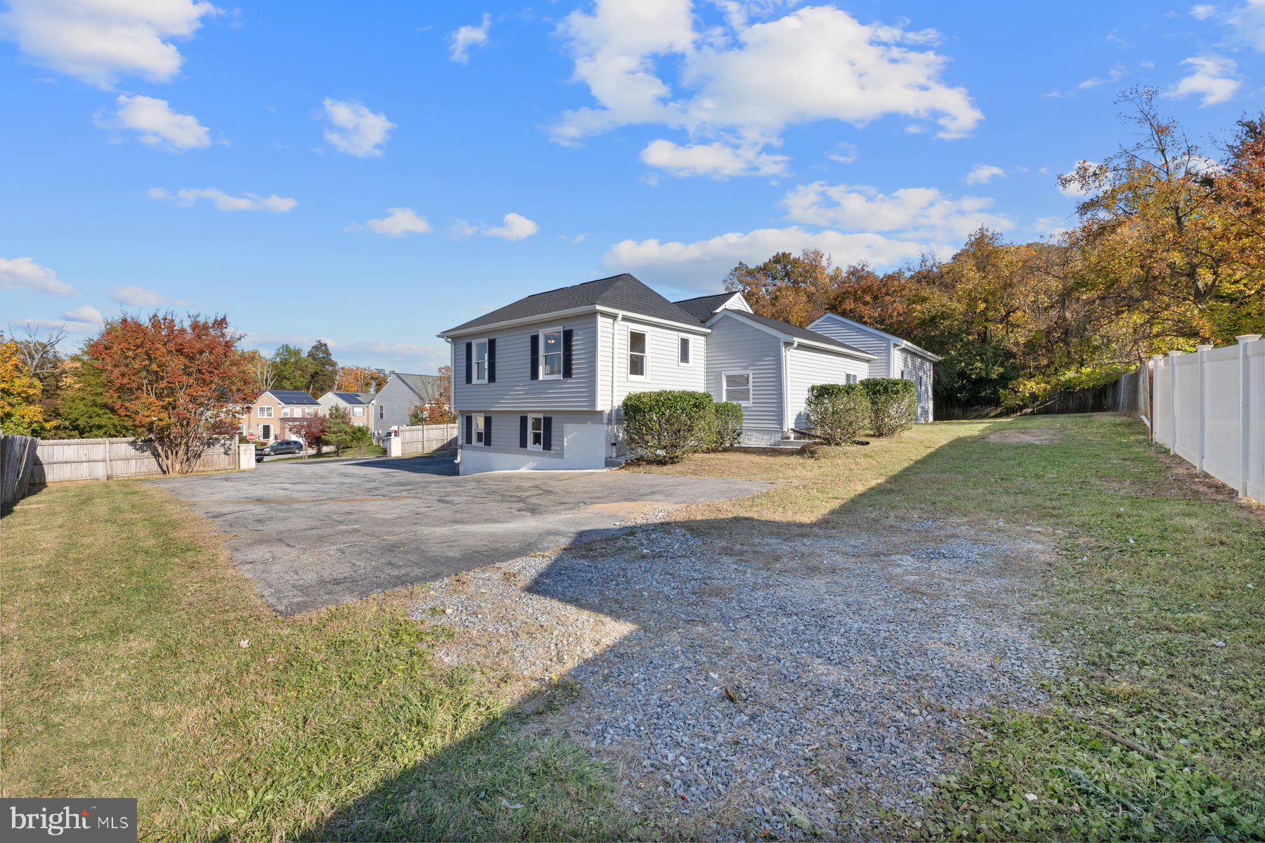 7005 Beacon Light Road Riverdale, MD 20737 - Photo 45 of 45 a front view of a house with a yard and trees