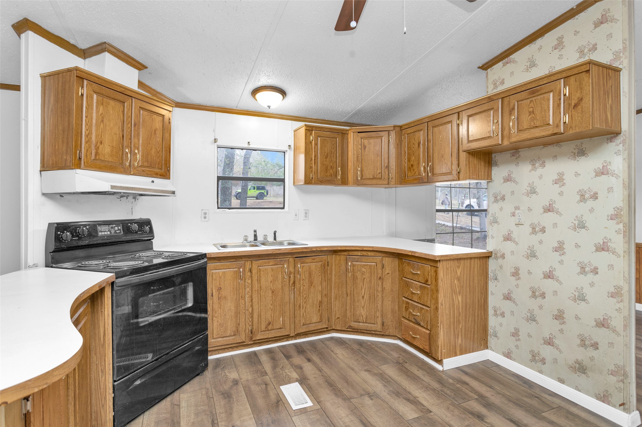 4794 Tall Pine Road Navasota, TX 77868 - Photo 12 of 34 a kitchen with stainless steel appliances granite countertop a stove a sink and a microwave