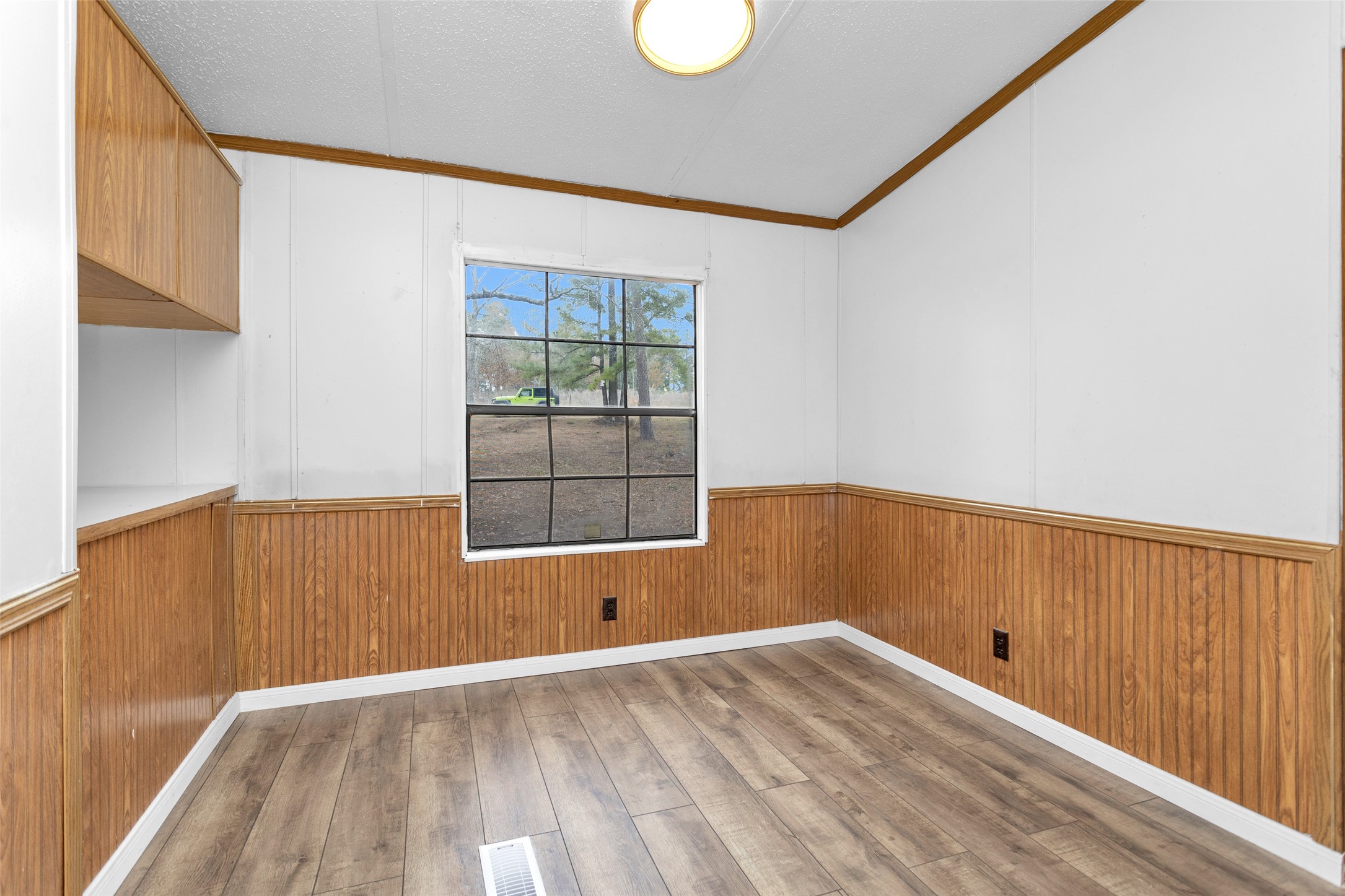 4794 Tall Pine Road Navasota, TX 77868 - Photo 15 of 34 a view of an empty room with wooden floor and a window