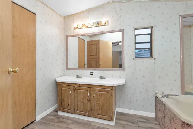 a backyard of a house with barbeque oven and floor to ceiling window