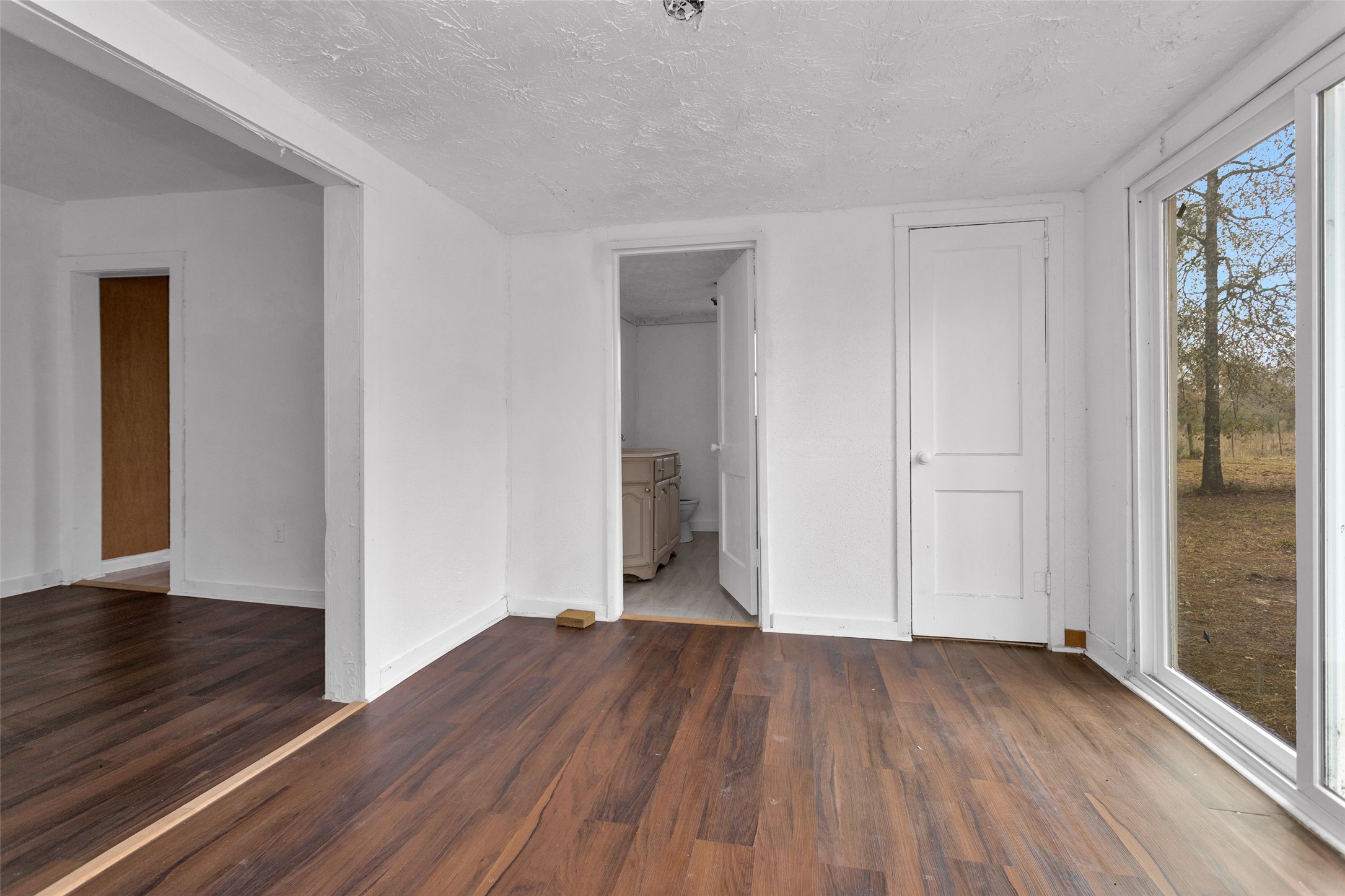 4794 Tall Pine Road Navasota, TX 77868 - Photo 30 of 34 an empty room with wooden floor and closet