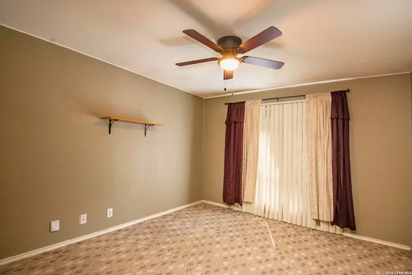 a view of a livingroom with a ceiling fan and window