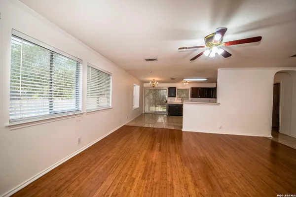 a view of a kitchen with wooden floor a sink and windows