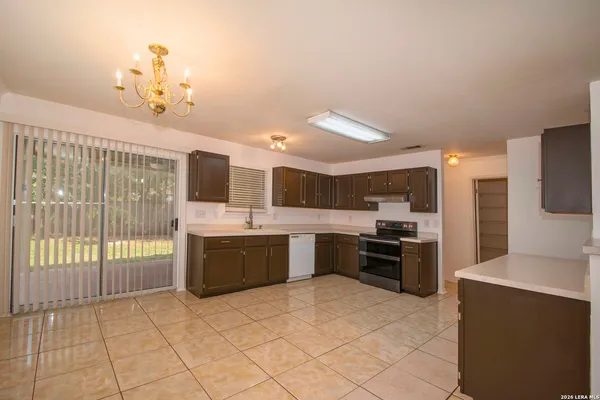 a large kitchen with a large counter top appliances and cabinets