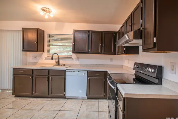 a kitchen with stainless steel appliances granite countertop a sink and a stove