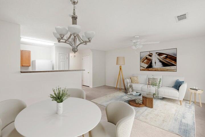 361 Crooked Pine Trail Crestview, FL 32539 - Photo 3 of 14 a living room with furniture flowers and a mirror