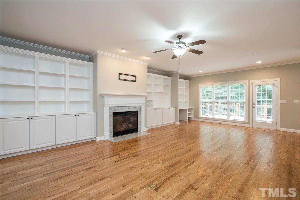 5245 Bartons Enclave Lane Raleigh, NC 27613 - Photo 2 of 27 Gleaming freshly refinished hardwood floors throughout main floor. Built-ins galore surround the gas fireplace. Gorgeous private views of the backyard , 2 tier decking for entertaining and Heated Saltwater Pool