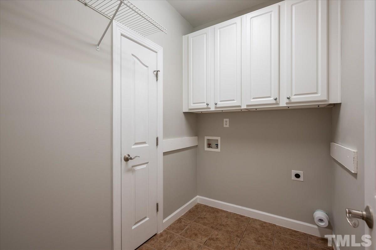 5245 Bartons Enclave Lane Raleigh, NC 27613 - Photo 14 of 27 Conveniently located on the main floor and complete with storage closet, overhead cabinets, and pre-plumbed for future utility sink if desired.