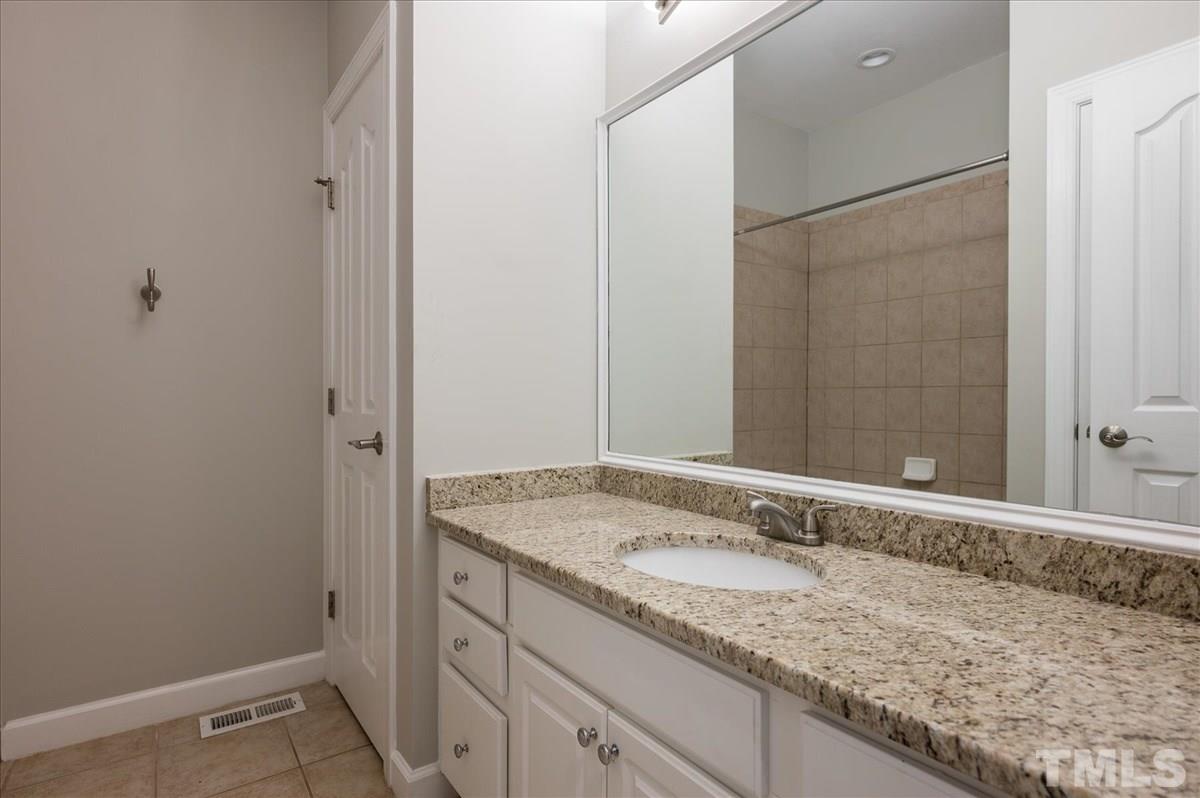 5245 Bartons Enclave Lane Raleigh, NC 27613 - Photo 18 of 27 complete with tiled shower/bath and granite countertops.