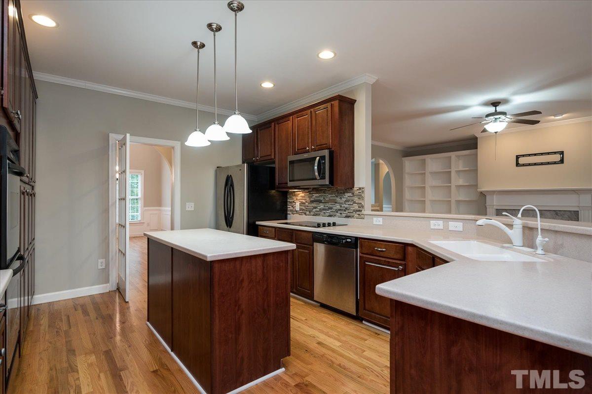 5245 Bartons Enclave Lane Raleigh, NC 27613 - Photo 5 of 27 Enjoy Peninsula seating at the bar for 4 .. All open and inviting to Family Room and Breakfast Room. Kitchen features swing door that leads to hall Butlers Pantry and Dining Room