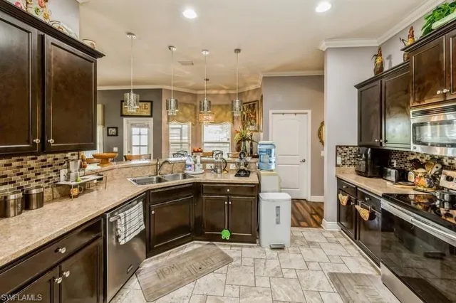a large kitchen with stainless steel appliances and a sink