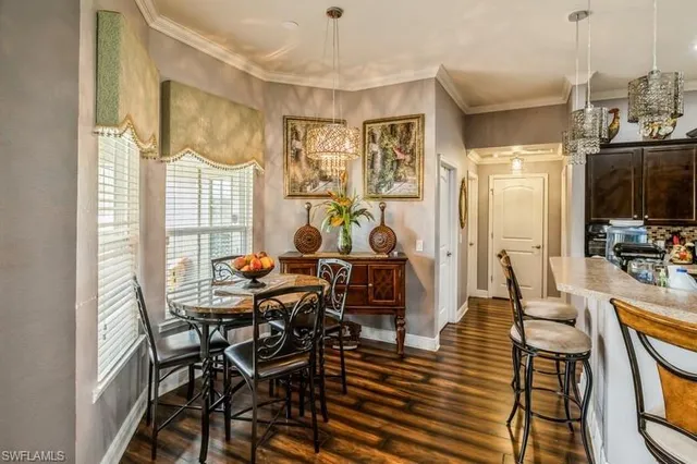 a dining room with furniture a chandelier and wooden floor