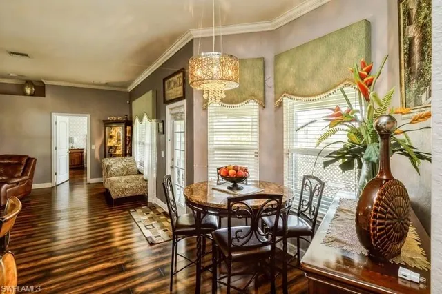 a dining room with furniture and wooden floor