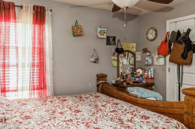 a bedroom with bed and a window