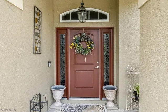 a floor to ceiling window and a potted plant