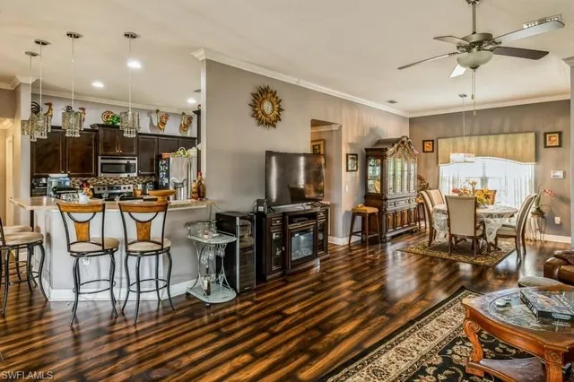 a living room with lots of furniture and wooden floors
