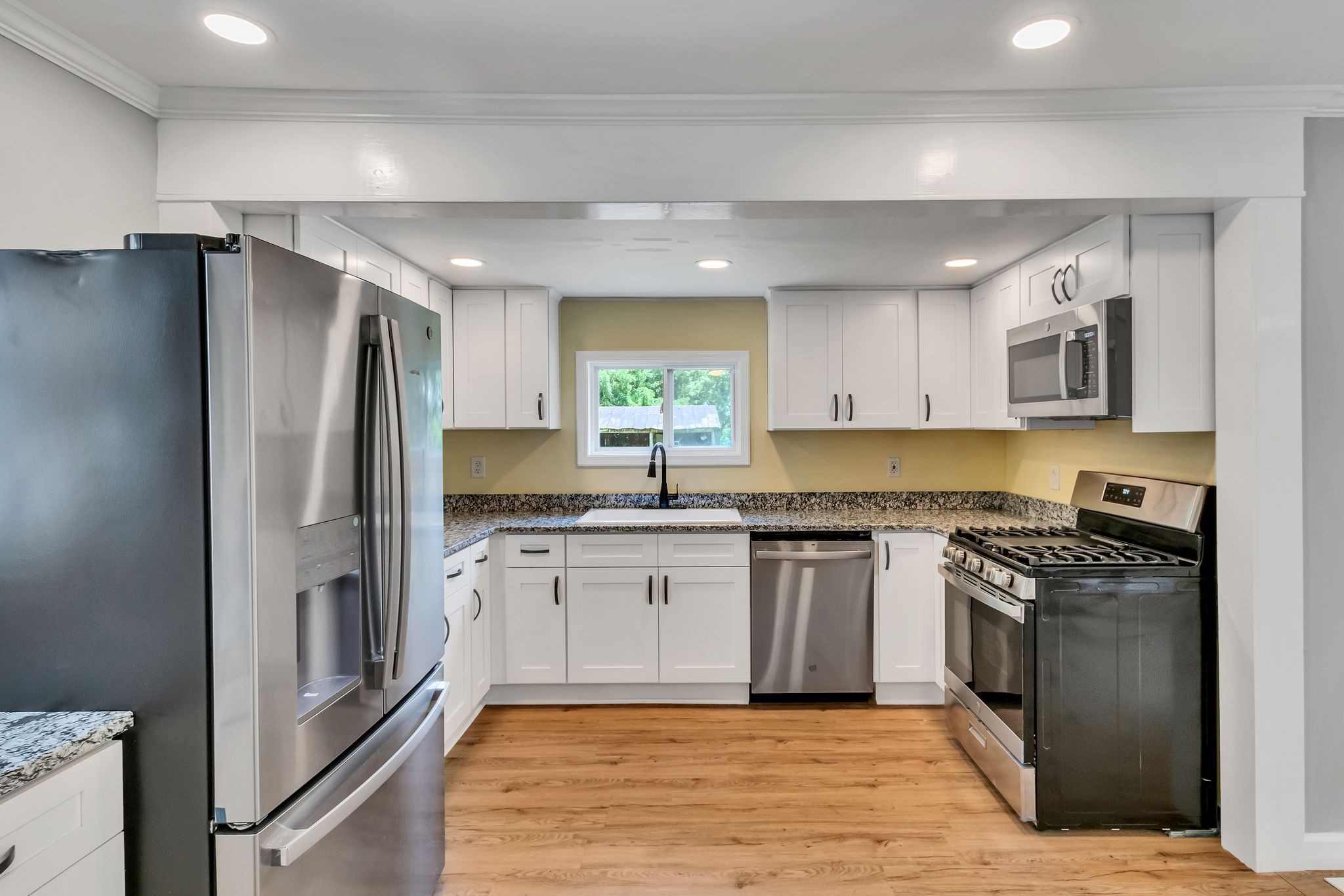 325 Francis Road Decherd, TN 37324 - Photo 13 of 27 a kitchen with granite countertop a refrigerator stove top oven and sink