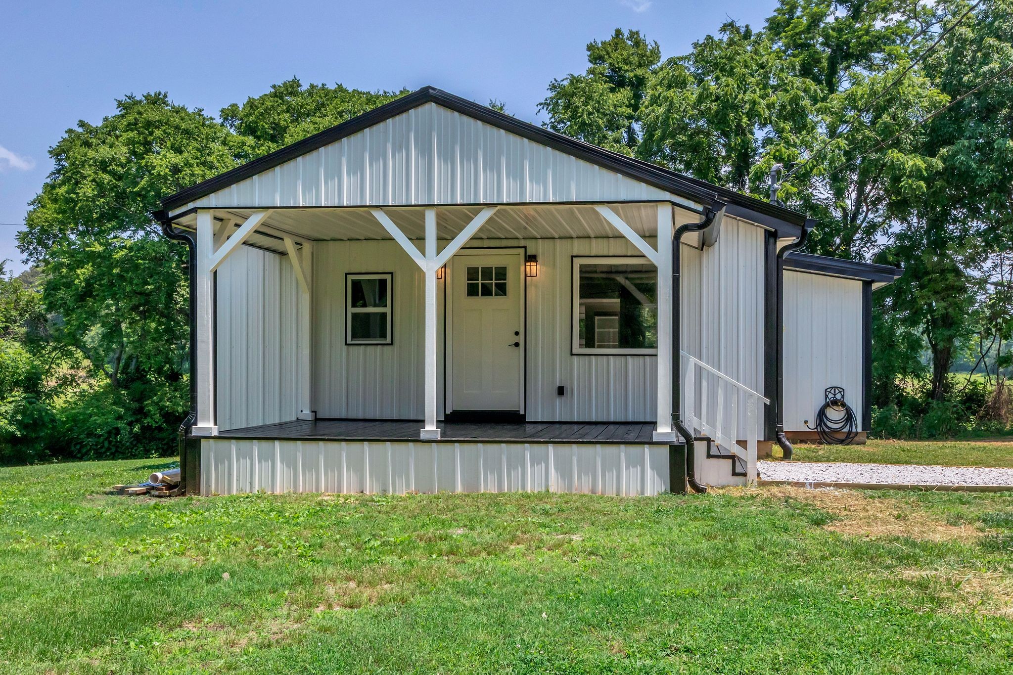 325 Francis Road Decherd, TN 37324 - Photo 4 of 27 a view of a small house in front of a big yard with large tree