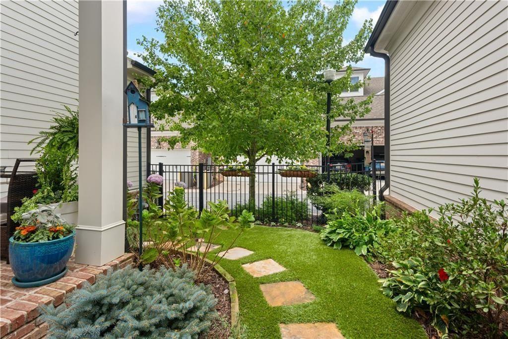 126 Academy Street Alpharetta, GA 30009 - Photo 61 of 74 a view of a garden with plants and a bench