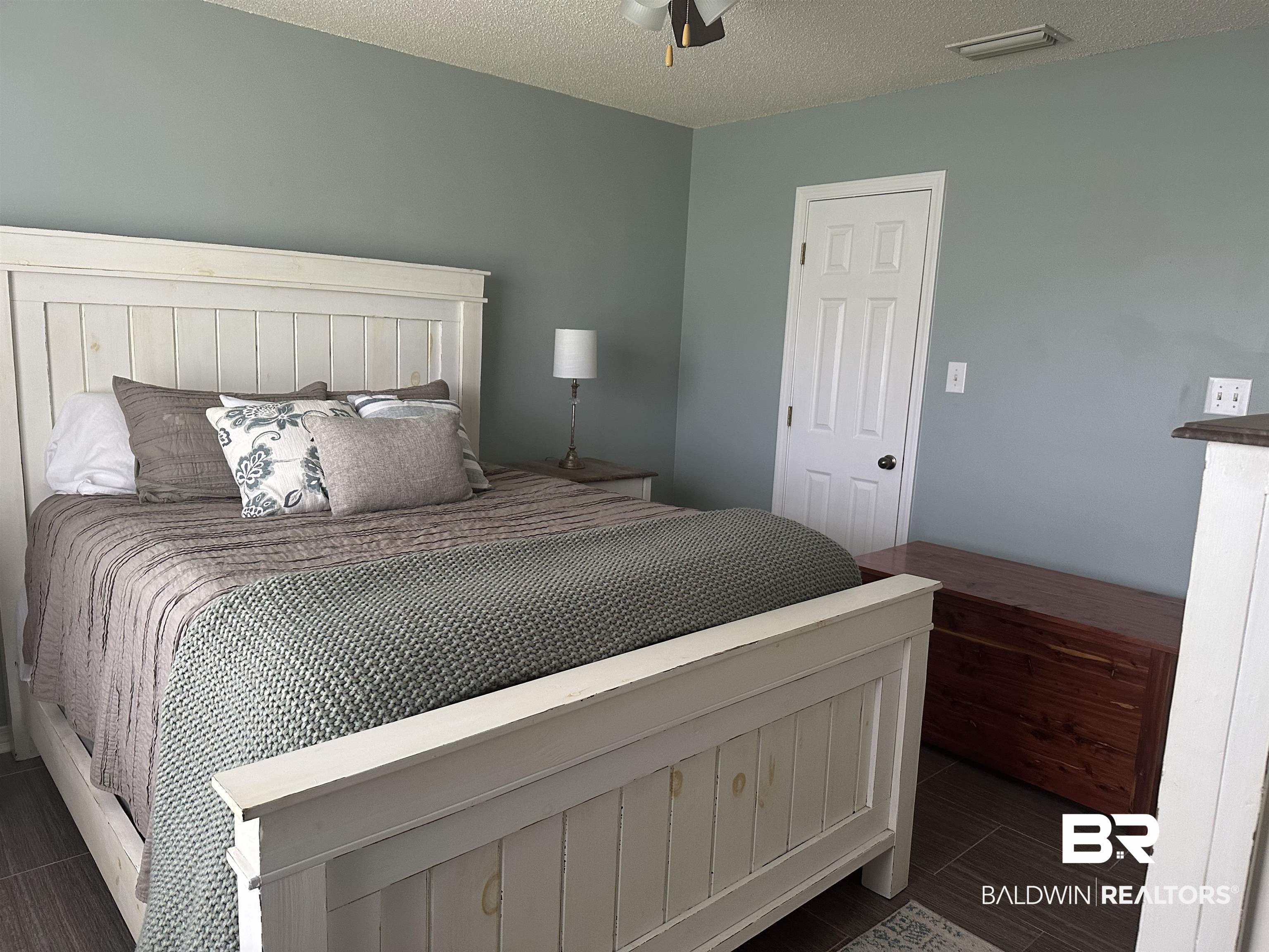 4882 Rebecca Place Mobile, AL 36695 - Photo 16 of 29 Bedroom featuring visible vents, a textured ceiling, and dark wood finished floors