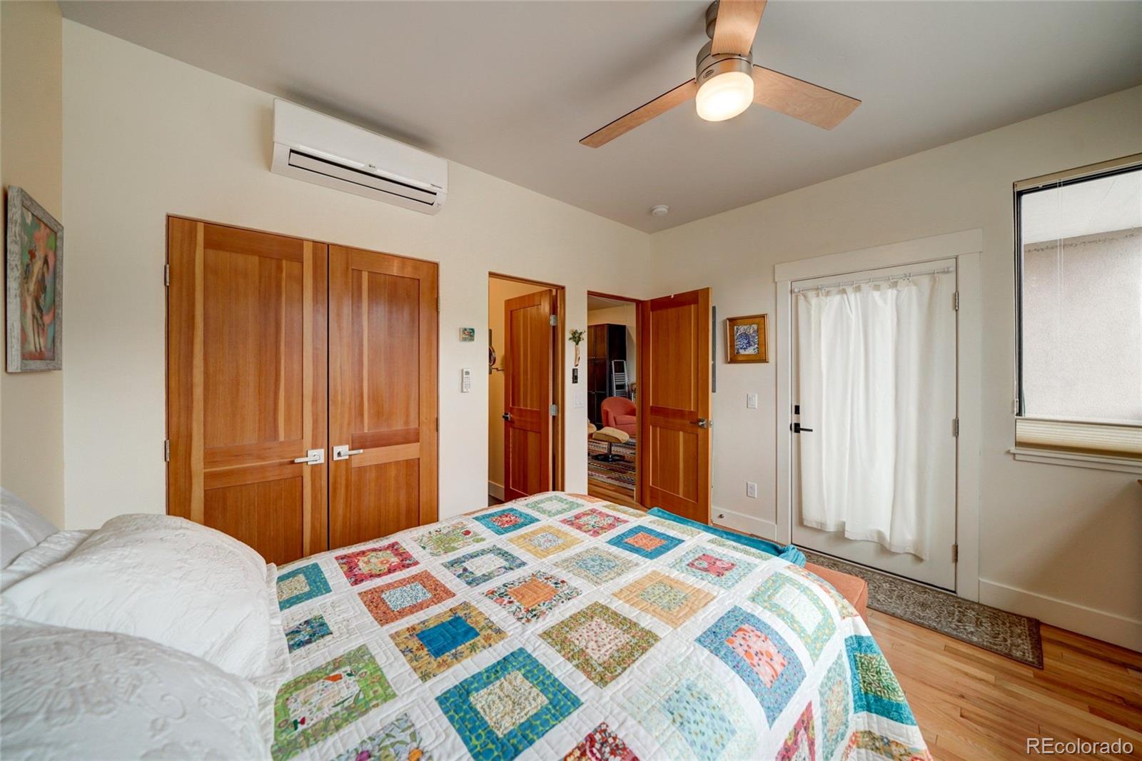 108 Old Stage Road, Unit C Salida, CO 81201 - Photo 13 of 30 a bedroom with a bed and a chandelier