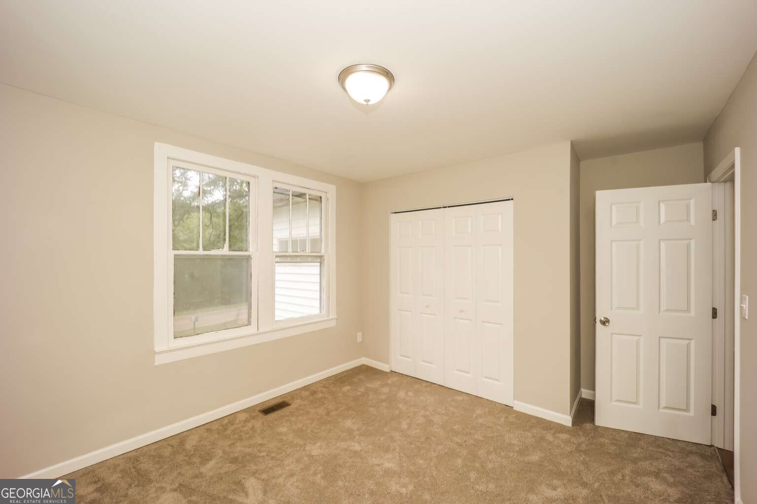 221 Power Plant Road Hogansville, GA 30230 - Photo 12 of 14 an empty room with windows and closet