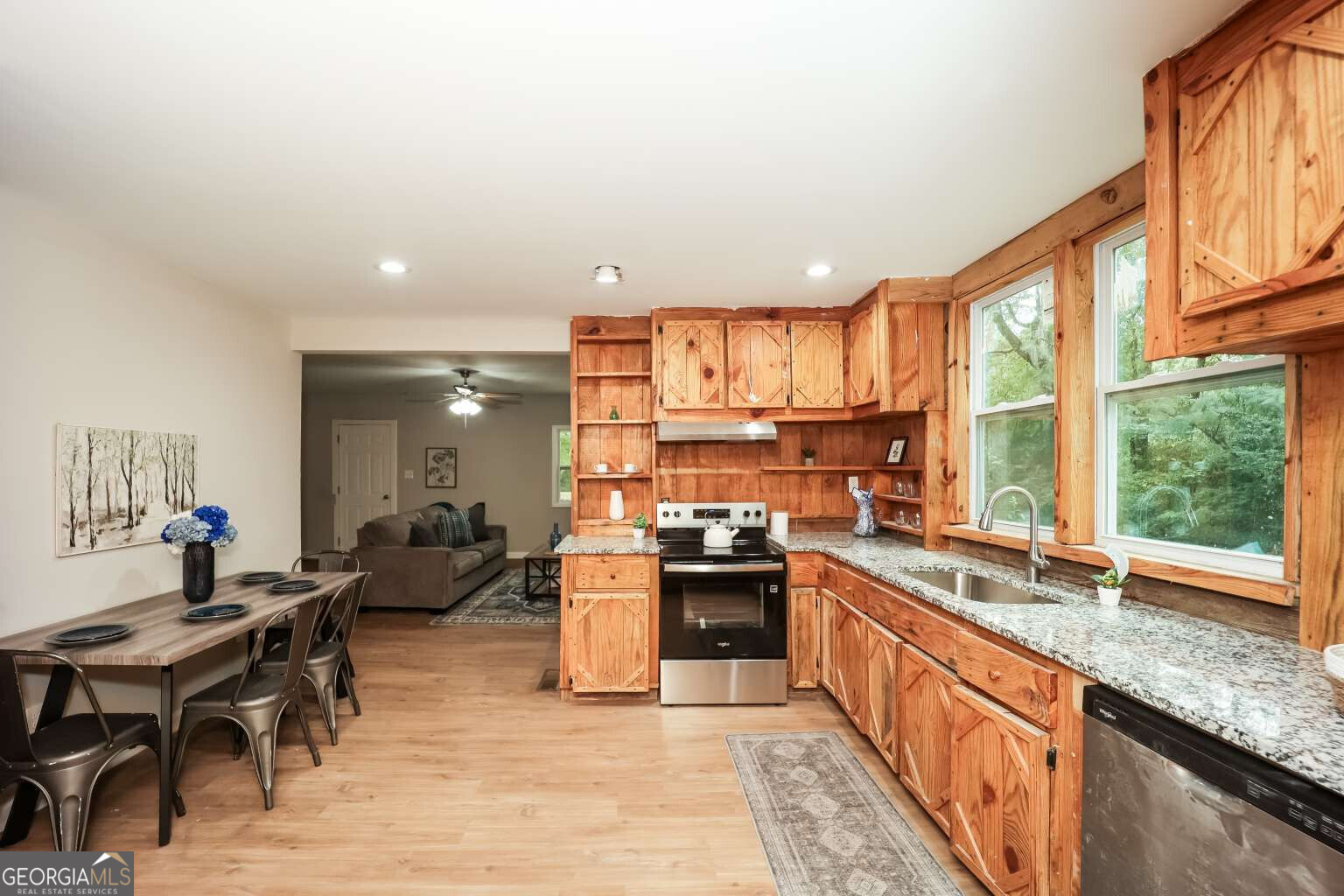 221 Power Plant Road Hogansville, GA 30230 - Photo 6 of 14 a kitchen with stainless steel appliances granite countertop sink stove top oven and cabinets