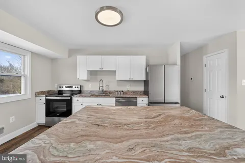 a kitchen with a stove and cabinets