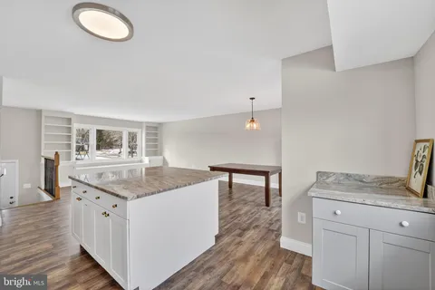 a kitchen with stainless steel appliances granite countertop a stove a sink and a wooden floors