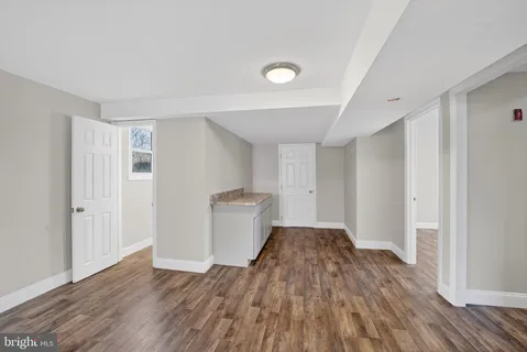 a view of a livingroom with wooden floor and staircase