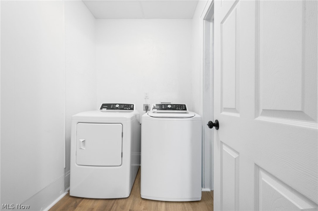 2140 Broadview Road Cleveland, OH 44109 - Photo 12 of 42 Washroom featuring electric dryer hookup, light hardwood / wood-style floors, and washing machine and clothes dryer