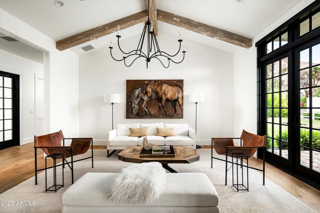 a spacious bedroom with a bed a couch and a flat screen tv