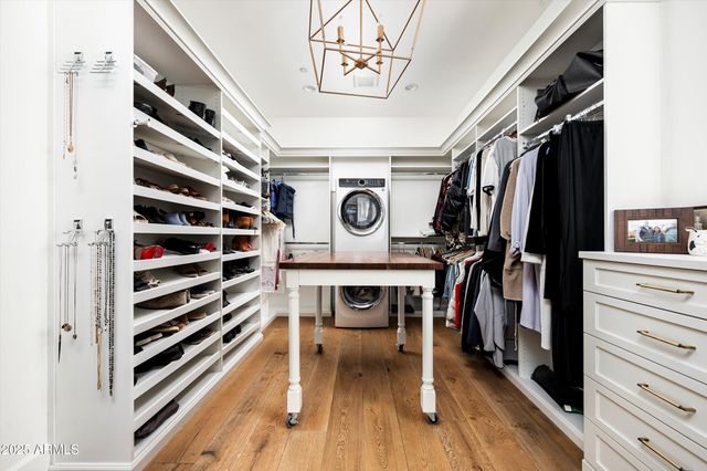 a bedroom with a bed tv and a window