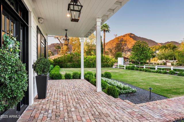 a view of a livingroom with furniture wooden floor windows and a chandelier