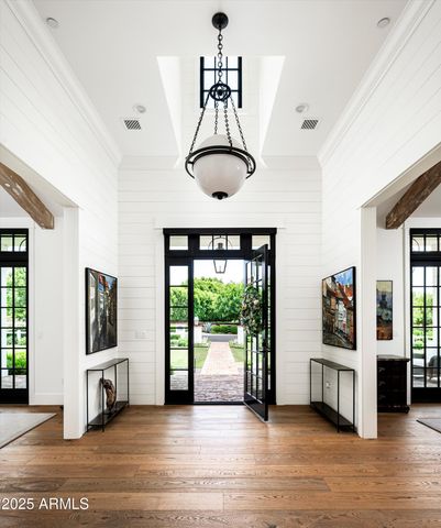 a living room with furniture fireplace and large windows