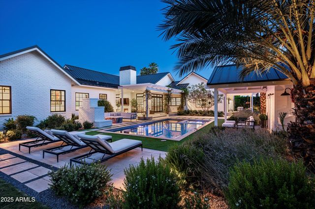 a front view of a house with a yard and trees