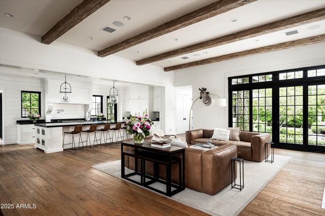 a living room with furniture a fireplace and a large window