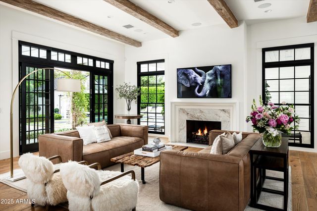 a kitchen with stainless steel appliances kitchen island granite countertop a sink a counter space and a window