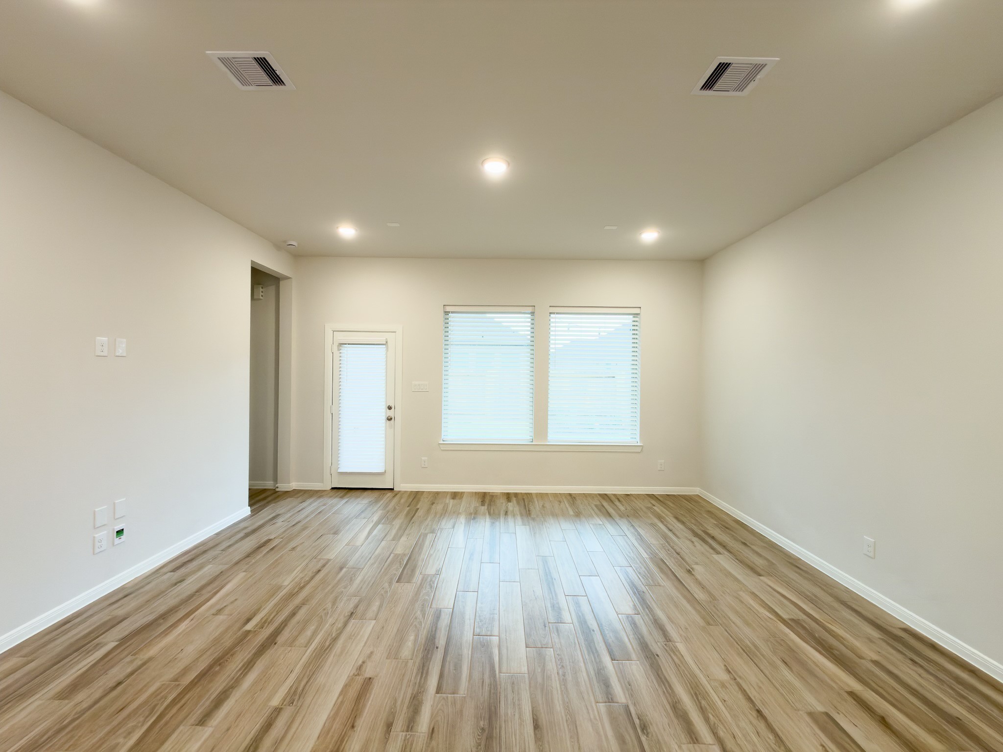 42504 Rustico Road Magnolia, TX 77354 - Photo 14 of 46 a view of an empty room with wooden floor and a window