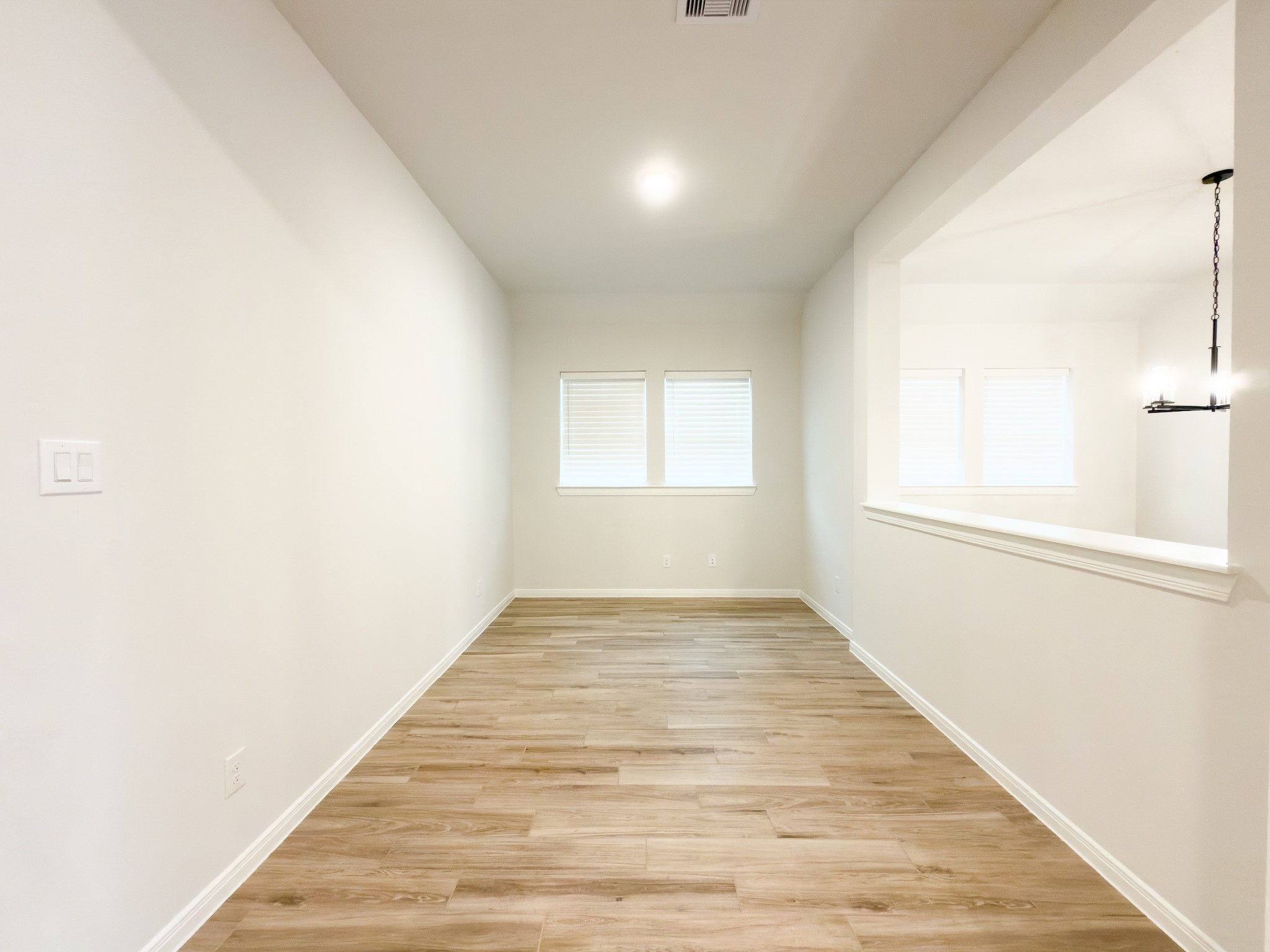 42504 Rustico Road Magnolia, TX 77354 - Photo 15 of 46 an empty room with wooden floor and windows
