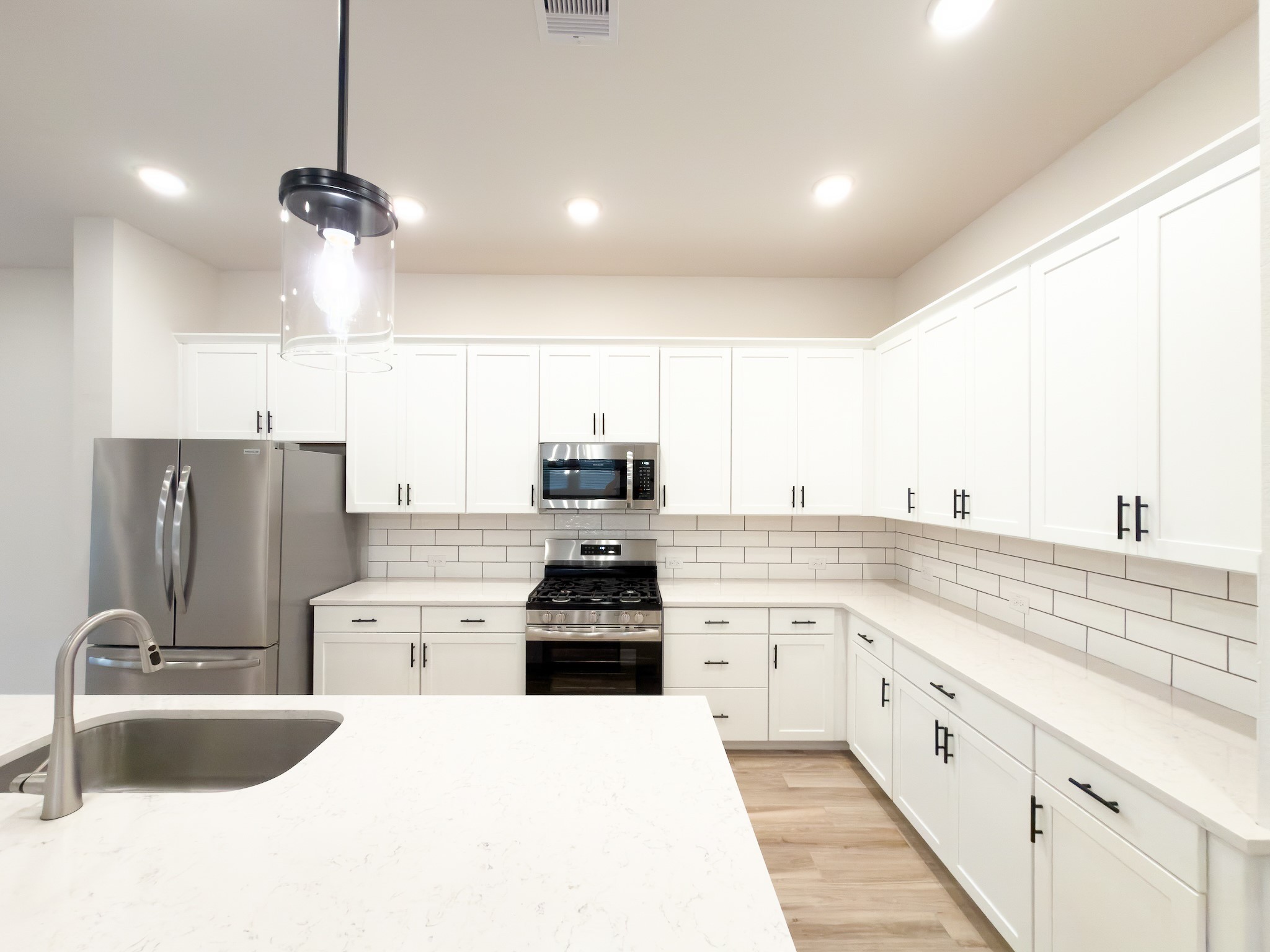 42504 Rustico Road Magnolia, TX 77354 - Photo 42 of 46 a large kitchen with stainless steel appliances kitchen island granite countertop a sink and cabinets
