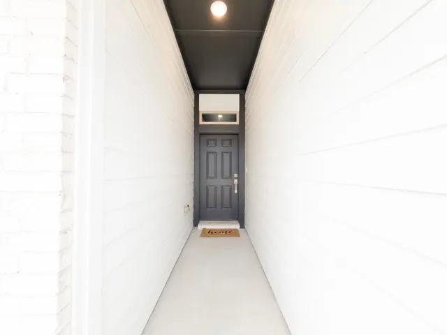 a view of backyard of house with green space