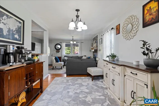a dining room with furniture potted plants and wooden floor