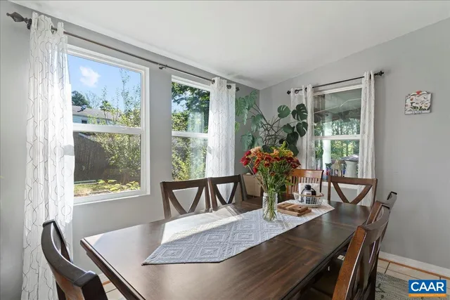 a living room with furniture flowerpot and wooden floor