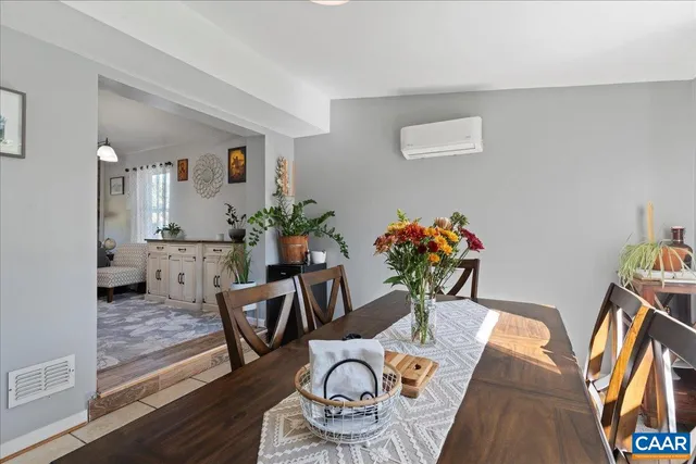 a view of a hallway with wooden floor and a living room