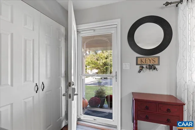 a living room with furniture a fireplace and a window