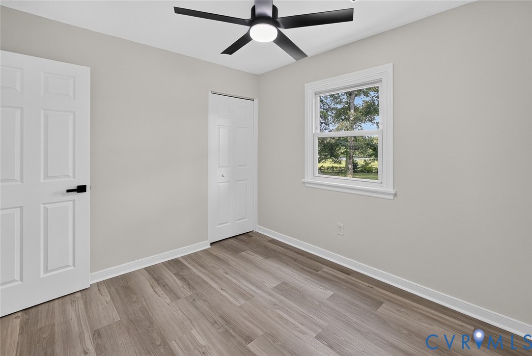 6581 Rural Point Road Mechanicsville, VA 23116 - Photo 18 of 58 Light gray walls, wood-finish flooring, white trim
